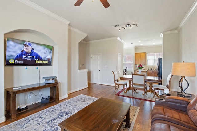 620 Cathedral Sq, Beaumont, TX 77701 - living room with wood finished floors, ceiling fan, crown molding, and baseboards