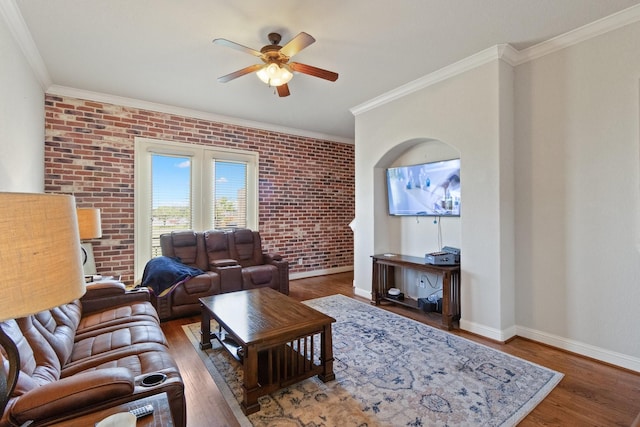 620 Cathedral Sq, Beaumont, TX 77701 - living room with a ceiling fan, brick wall, wood finished floors, crown molding, and baseboards