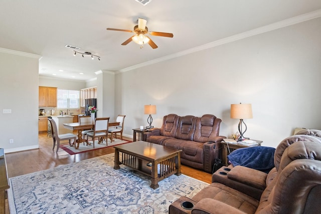 620 Cathedral Sq, Beaumont, TX 77701 - living area featuring light wood-style flooring, a ceiling fan, ornamental molding, and baseboards