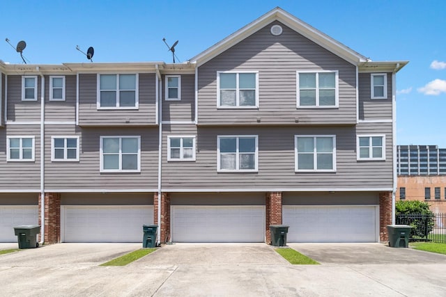 620 Cathedral Sq, Beaumont, TX 77701 - view of front of house with brick siding, a garage, and driveway