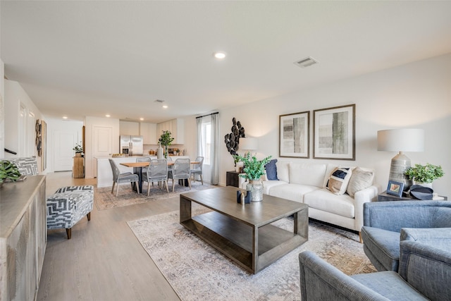 3025 Wild Dunes Dr, Katy, TX 77493 - living room featuring light wood-style flooring and recessed lighting