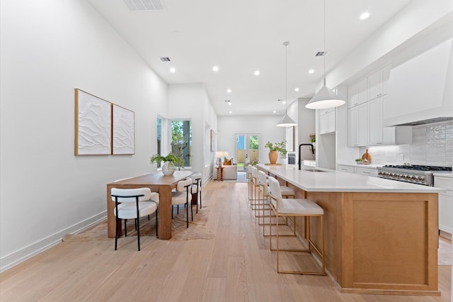 322 Aurora St, Houston, TX 77008 - kitchen featuring a sink, custom range hood, light wood-style floors, recessed lighting, and light countertops
