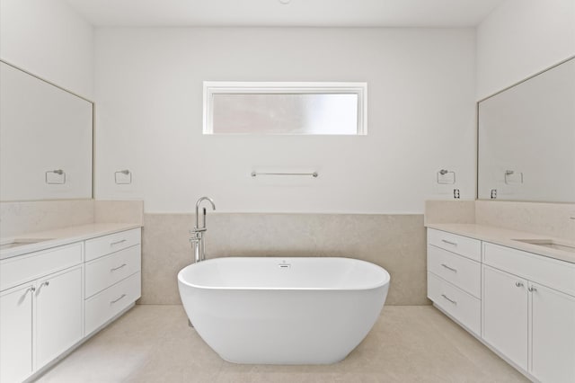 322 Aurora St, Houston, TX 77008 - bathroom featuring two vanities, a freestanding tub, a wainscoted wall, and tile walls