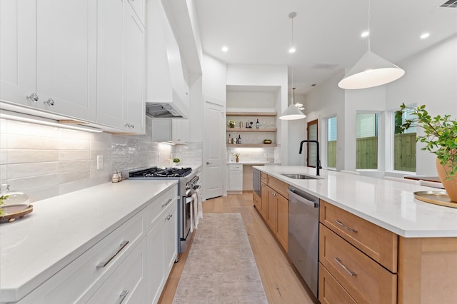 322 Aurora St, Houston, TX 77008 - kitchen with appliances with stainless steel finishes, a sink, open shelves, backsplash, and light wood-style flooring