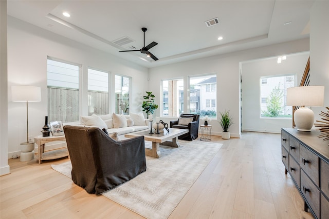 2015 Hopkins St, Houston, TX 77006 - living area featuring a raised ceiling, light wood-style flooring, ceiling fan, healthy amount of natural light, and recessed lighting
