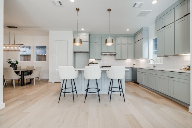 2015 Hopkins St, Houston, TX 77006 - kitchen with backsplash, light countertops, light wood-type flooring, healthy amount of natural light, and recessed lighting