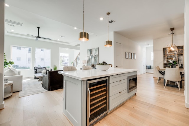 2015 Hopkins St, Houston, TX 77006 - kitchen with beverage cooler, open floor plan, light wood finished floors, and recessed lighting
