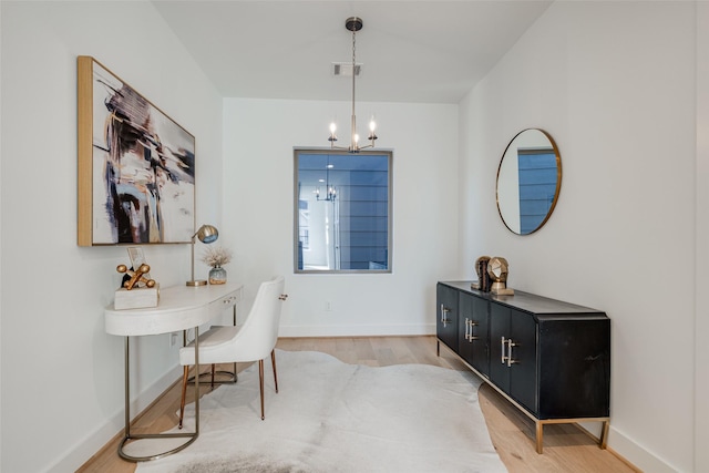 2015 Hopkins St, Houston, TX 77006 - home office featuring a chandelier, light wood-style flooring, and baseboards