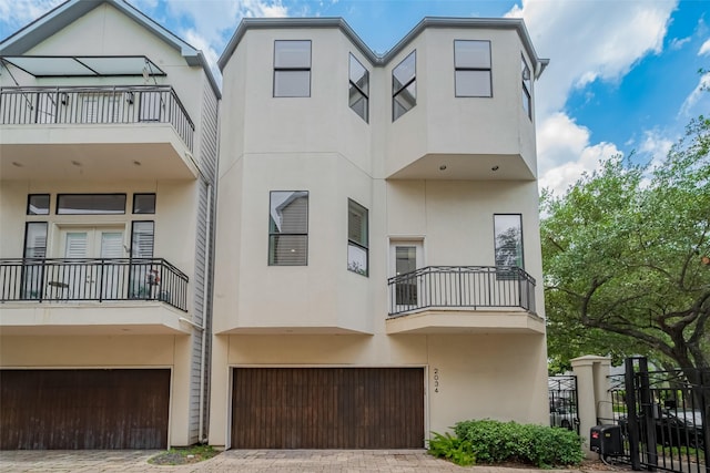 2034 Colquitt St Unit A, Houston, TX 77098 - view of building exterior featuring a garage and decorative driveway