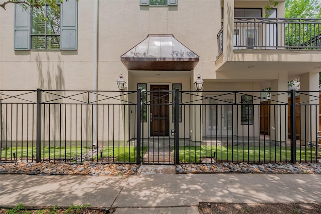 2034 Colquitt St Unit A, Houston, TX 77098 - view of exterior entry with stucco siding, a balcony, and a gate