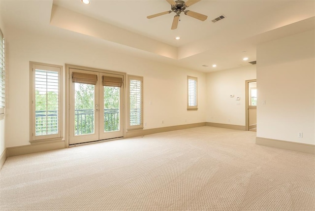 2034 Colquitt St Unit A, Houston, TX 77098 - unfurnished room with light carpet, a tray ceiling, a ceiling fan, baseboards, and recessed lighting