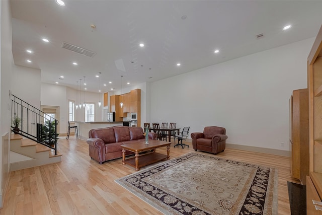 2034 Colquitt St Unit A, Houston, TX 77098 - living room featuring light wood-type flooring, stairway, recessed lighting, and baseboards