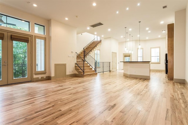 2034 Colquitt St Unit A, Houston, TX 77098 - unfurnished living room with light wood-type flooring, stairway, recessed lighting, and baseboards
