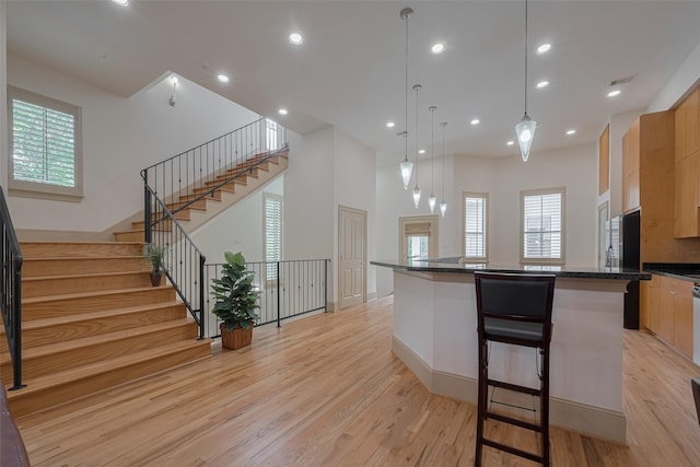 2034 Colquitt St Unit A, Houston, TX 77098 - kitchen featuring light wood-type flooring, dark countertops, a kitchen island, plenty of natural light, and recessed lighting