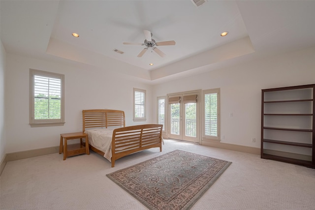 2034 Colquitt St Unit A, Houston, TX 77098 - bedroom with light colored carpet, multiple windows, access to outside, a tray ceiling, and recessed lighting
