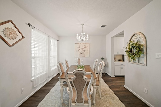 358 Cavil Barrier Ln, La Porte, TX 77571 - dining area with a chandelier, dark wood-type flooring, and baseboards
