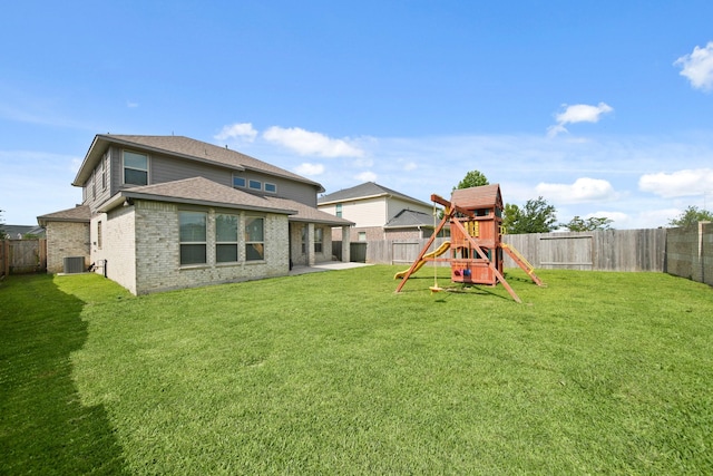 358 Cavil Barrier Ln, La Porte, TX 77571 - back of house with a playground, brick siding, a patio area, and roof with shingles