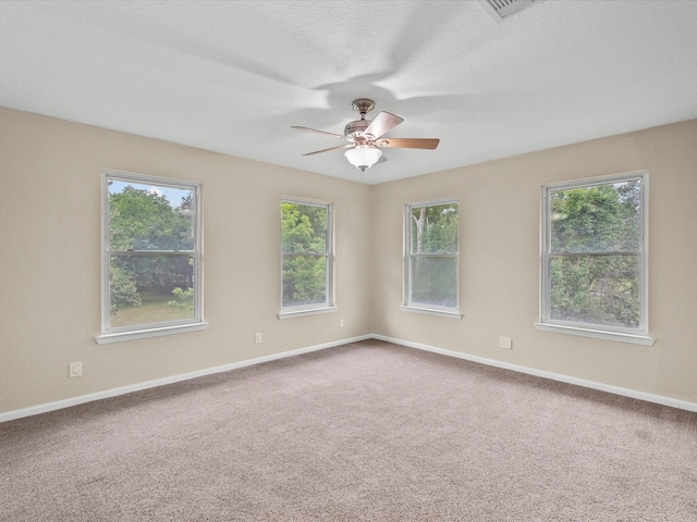 3422 N Elm Rd, Santa Fe, TX 77517 - empty room featuring ceiling fan, healthy amount of natural light, carpet floors, and baseboards