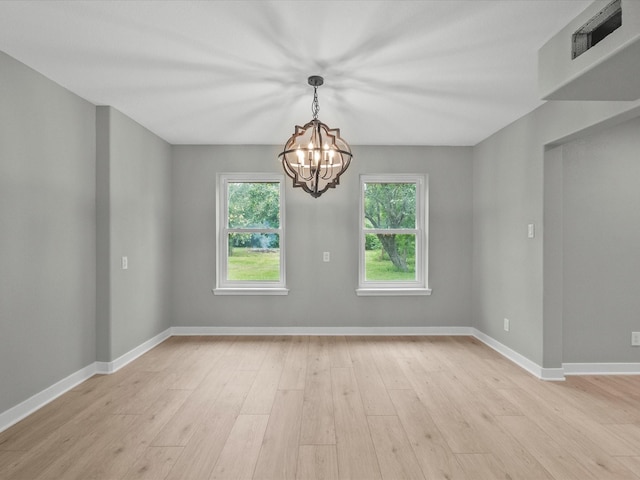 3422 N Elm Rd, Santa Fe, TX 77517 - spare room featuring a chandelier, light wood-style floors, and baseboards