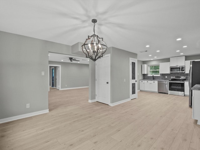 3422 N Elm Rd, Santa Fe, TX 77517 - kitchen featuring appliances with stainless steel finishes, open floor plan, a chandelier, baseboards, and a ceiling fan