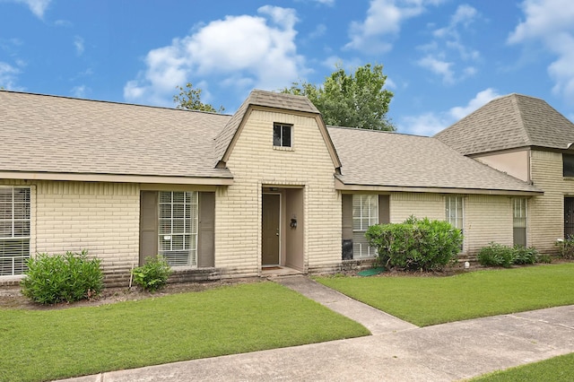 7162 Crownwest St Unit 7162, Houston, TX 77072 - view of front facade with brick siding, a shingled roof, and a front lawn