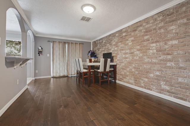 7162 Crownwest St Unit 7162, Houston, TX 77072 - dining room featuring a textured ceiling, baseboards, arched walkways, ornamental molding, and wood finished floors