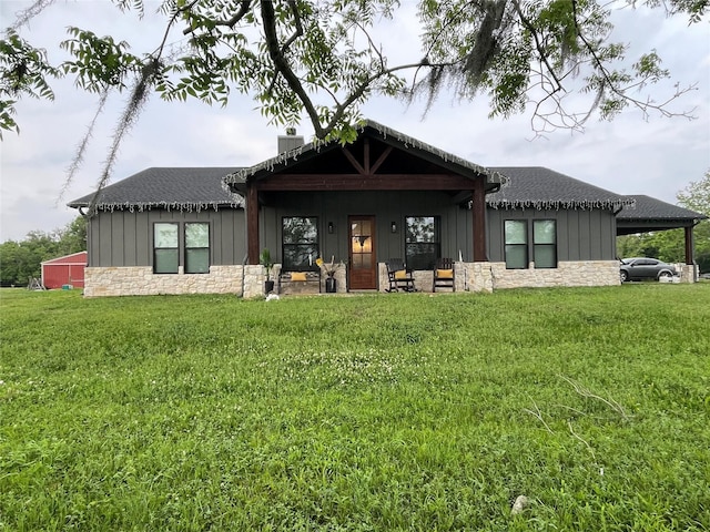 3295 Fm 524, Sweeny, TX 77480 - back of house with stone siding, board and batten siding, a yard, a carport, and roof with shingles