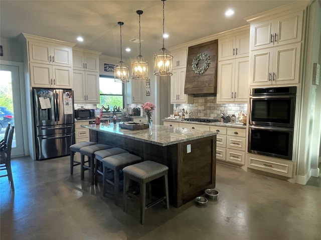 3295 Fm 524, Sweeny, TX 77480 - kitchen featuring stainless steel appliances, finished concrete flooring, tasteful backsplash, a center island, and light stone countertops