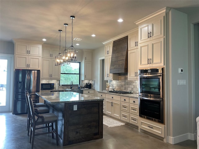 3295 Fm 524, Sweeny, TX 77480 - kitchen featuring black appliances, finished concrete flooring, decorative backsplash, a center island, and dark stone countertops