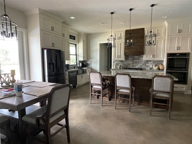 3295 Fm 524, Sweeny, TX 77480 - kitchen with black appliances, a chandelier, backsplash, concrete flooring, and a sink
