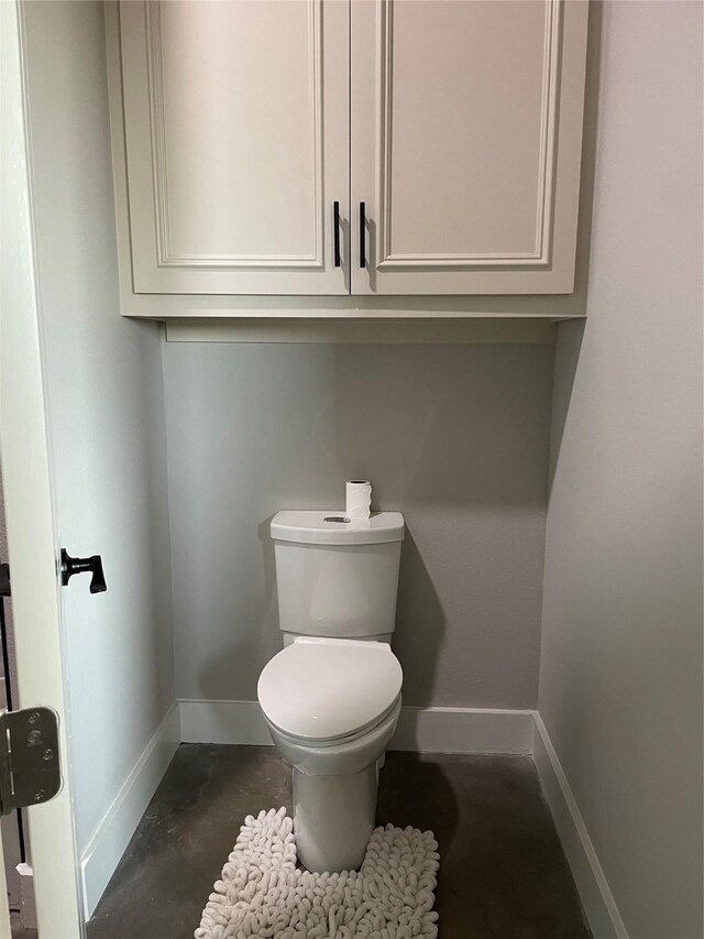 3295 Fm 524, Sweeny, TX 77480 - bathroom featuring baseboards, toilet, and concrete floors