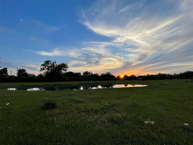 3295 Fm 524, Sweeny, TX 77480 - yard at dusk featuring a water view and a yard
