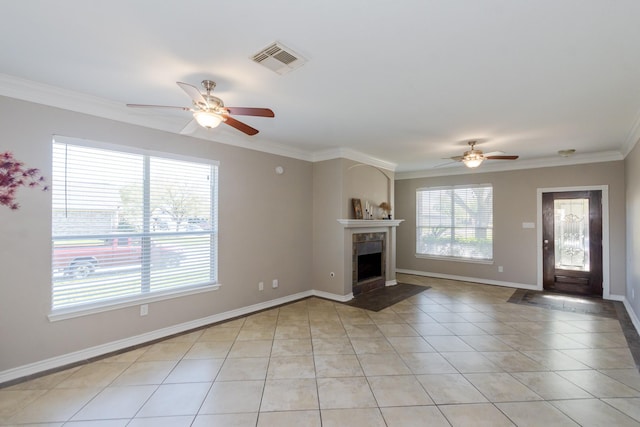1802 Dominic Ln, Houston, TX 77049 - unfurnished living room with a ceiling fan, crown molding, light tile patterned floors, a tiled fireplace, and baseboards