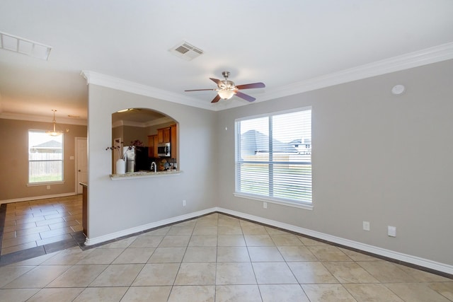 1802 Dominic Ln, Houston, TX 77049 - empty room with light tile patterned flooring, healthy amount of natural light, ornamental molding, and ceiling fan