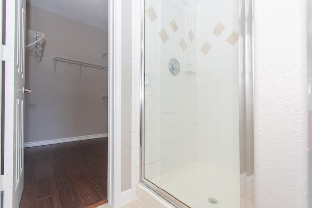 1802 Dominic Ln, Houston, TX 77049 - full bath with a shower stall, a walk in closet, and wood finished floors