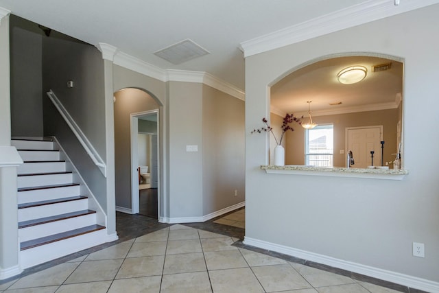 1802 Dominic Ln, Houston, TX 77049 - tiled spare room featuring arched walkways, crown molding, baseboards, stairway, and inlaid floor details