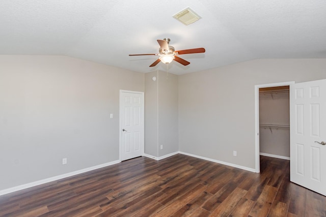 1802 Dominic Ln, Houston, TX 77049 - unfurnished bedroom featuring vaulted ceiling, dark wood finished floors, a walk in closet, a closet, and baseboards