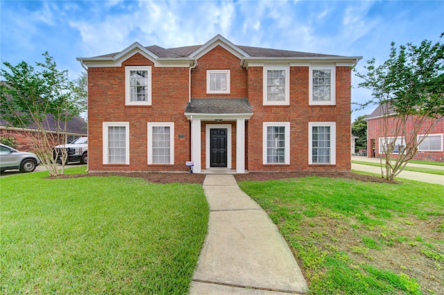 1322 Village Garden Dr, Missouri City, TX 77459 - view of front facade with a front lawn and brick siding