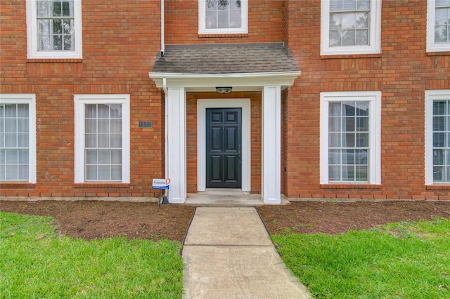 1322 Village Garden Dr, Missouri City, TX 77459 - doorway to property featuring roof with shingles and brick siding