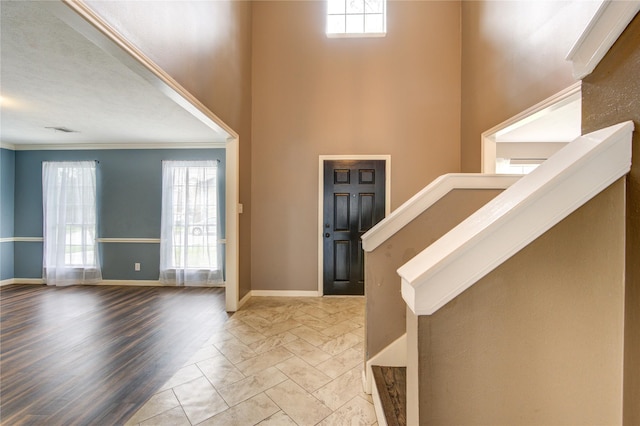 1322 Village Garden Dr, Missouri City, TX 77459 - foyer with crown molding, marble look tile flooring, a towering ceiling, and stairs