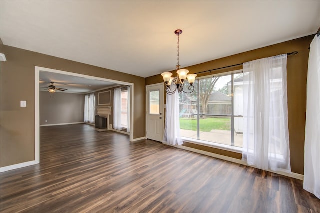 1322 Village Garden Dr, Missouri City, TX 77459 - unfurnished dining area with a chandelier, dark wood-style flooring, a fireplace, and ceiling fan
