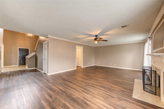 1322 Village Garden Dr, Missouri City, TX 77459 - unfurnished living room with ceiling fan, a fireplace, dark wood-type flooring, crown molding, and a chandelier