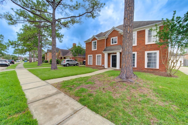 1322 Village Garden Dr, Missouri City, TX 77459 - view of front facade featuring a front lawn and brick siding