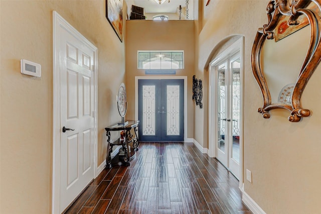 8215 Frontenac Dr, Houston, TX 77071 - foyer entrance featuring french doors, baseboards, dark wood-type flooring, and a high ceiling