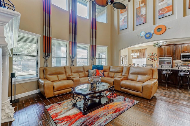 8215 Frontenac Dr, Houston, TX 77071 - living area with a towering ceiling, dark wood-style floors, ceiling fan, and baseboards