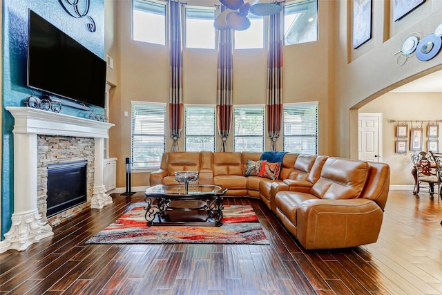 8215 Frontenac Dr, Houston, TX 77071 - living area featuring a high ceiling, a ceiling fan, wood finished floors, a fireplace, and baseboards