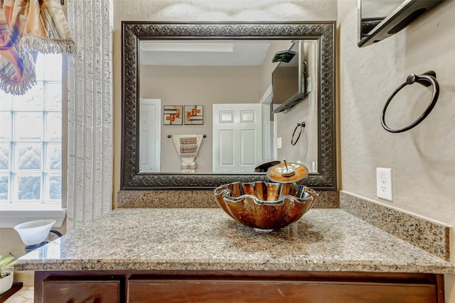8215 Frontenac Dr, Houston, TX 77071 - bathroom with vanity, a textured wall, and plenty of natural light