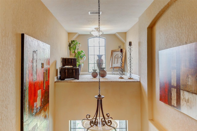 8215 Frontenac Dr, Houston, TX 77071 - kitchen featuring plenty of natural light, a textured wall, and pendant lighting