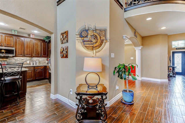 8215 Frontenac Dr, Houston, TX 77071 - kitchen with appliances with stainless steel finishes, ornate columns, a towering ceiling, light countertops, and baseboards