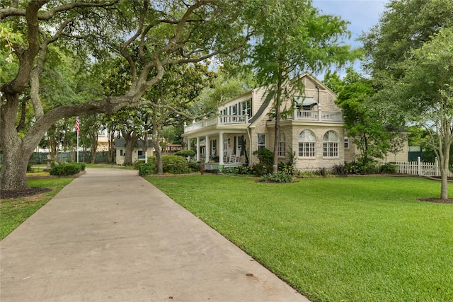916 E James St, Baytown, TX 77520 - view of front of home with a balcony and stone siding